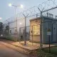 Fenced electrical substation at dusk with warning signs