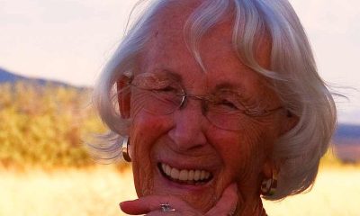 Smiling elderly woman outdoors at sunset