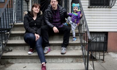 Family sitting on apartment steps with toddler