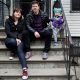 Family sitting on apartment steps with toddler