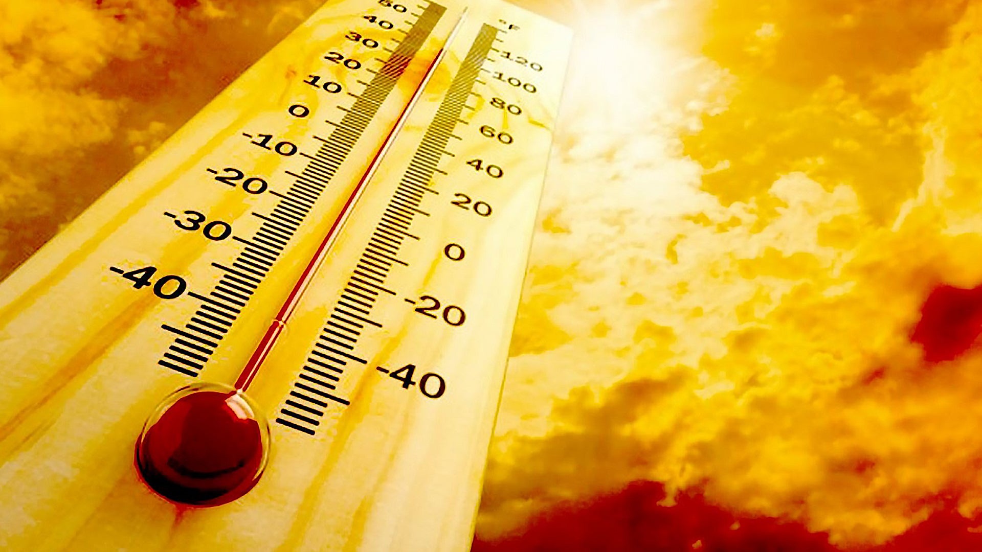 Thermometer showing high temperature against bright sky