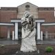 Stone family sculpture outside brick building entrance
