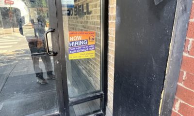 Taco Bell door with now hiring sign