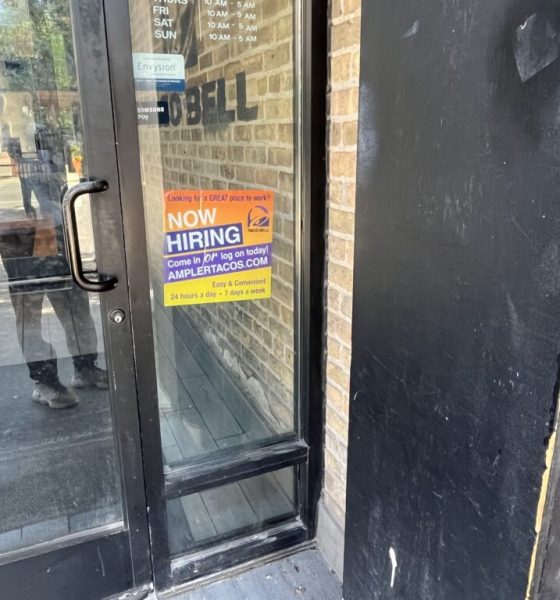 Taco Bell door with now hiring sign