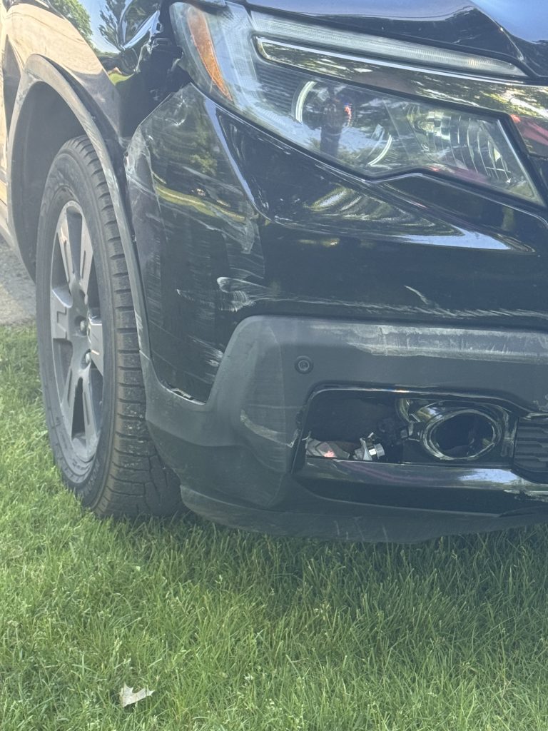 Damaged front bumper and headlight of Black Lawn Rangers pickup that was involved in the single vehicle crash in front of the freeze at 1 pm on 8 June 2026