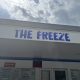 The Freeze ice cream stand sign under cloudy sky