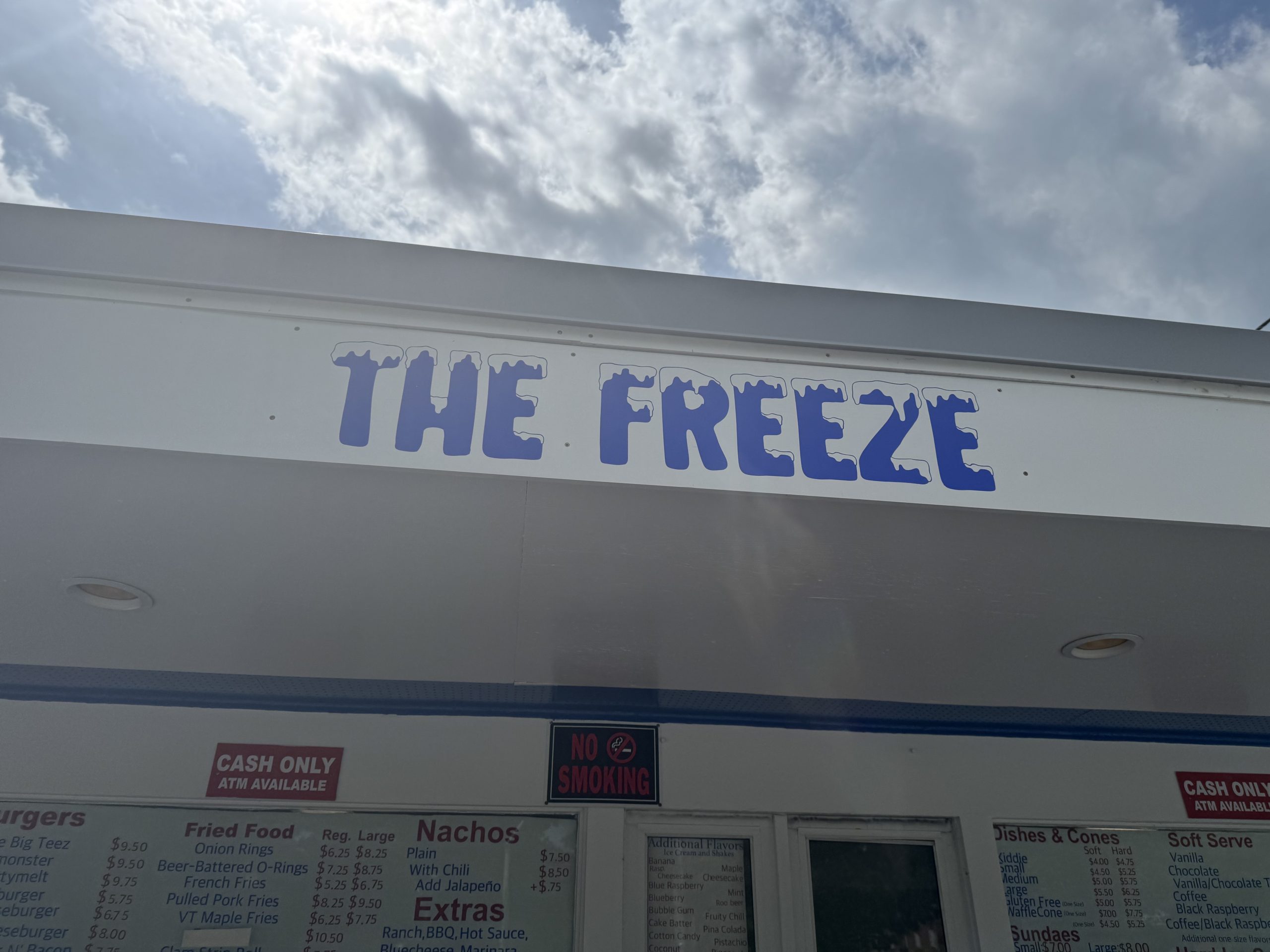 The Freeze ice cream stand sign under cloudy sky