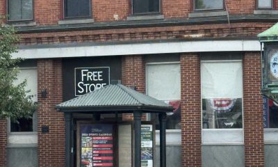 Brick building with bus shelter and Free Store sign