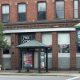 Brick building with bus shelter and Free Store sign