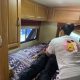 Woman comforting person lying on RV bed