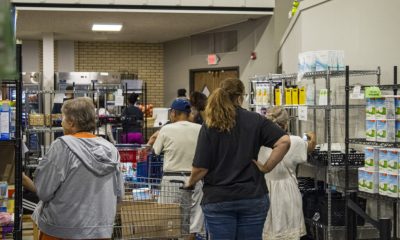 People shopping at indoor food pantry shelves