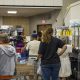 People shopping at indoor food pantry shelves