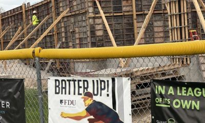 Construction site behind fence with baseball banners