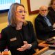 Woman presenting at meeting with colleagues and laptop