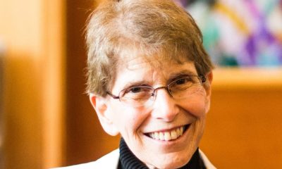 Smiling older woman with glasses indoors