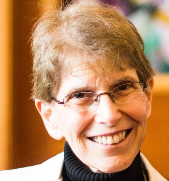 Smiling older woman with glasses indoors