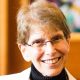 Smiling older woman with glasses indoors