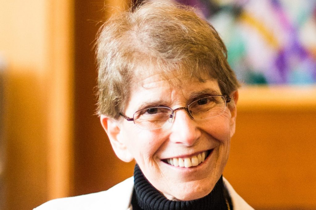 Smiling older woman with glasses indoors
