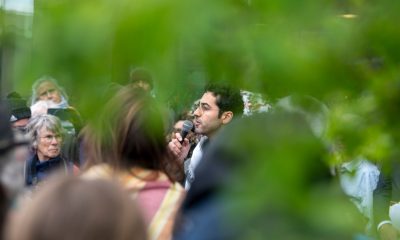 Man speaking into microphone at outdoor gathering