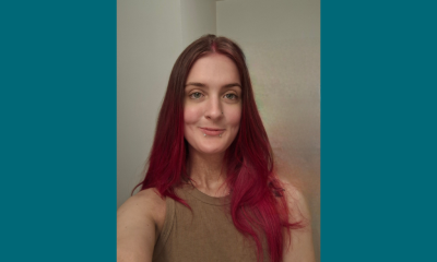 Woman with long red hair taking selfie indoors