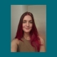 Woman with long red hair taking selfie indoors