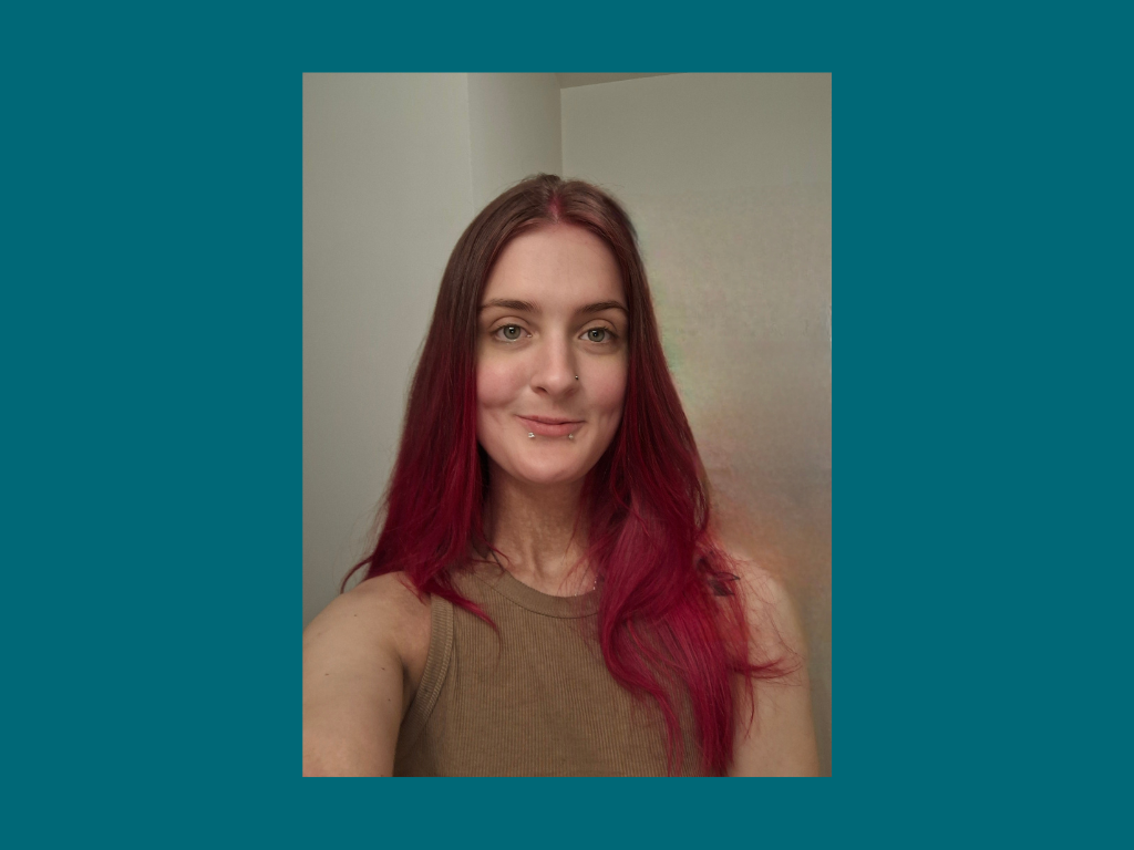 Woman with long red hair taking selfie indoors