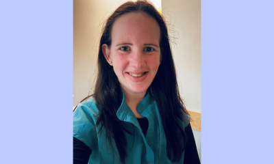 Smiling woman in teal top indoors portrait