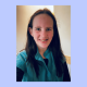 Smiling woman in teal top indoors portrait