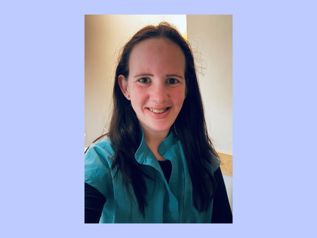 Smiling woman in teal top indoors portrait