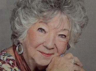 Smiling elderly woman with curly gray hair portrait