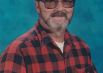 Man with glasses in red plaid shirt