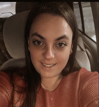 Woman taking selfie inside a parked car