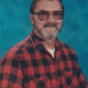 Man with glasses in red plaid shirt