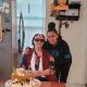 Elderly woman with birthday cake and younger companion