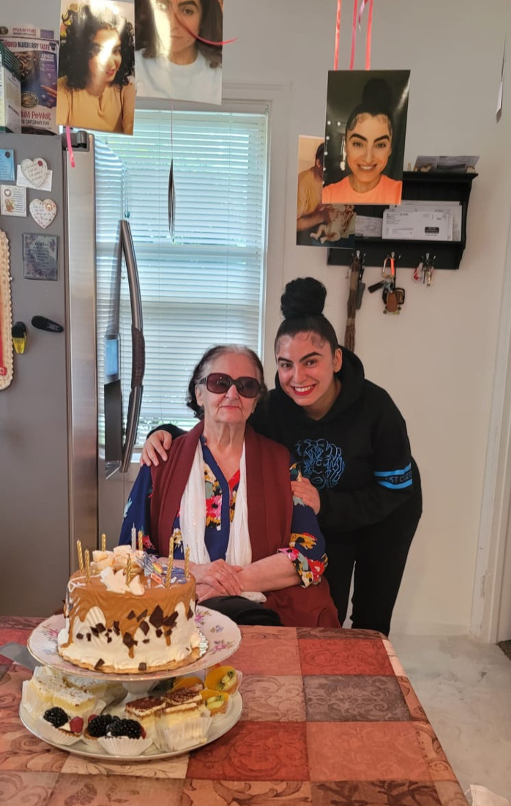 Elderly woman with birthday cake and younger companion