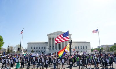 Protesters outside U.S. Supreme Court with flags