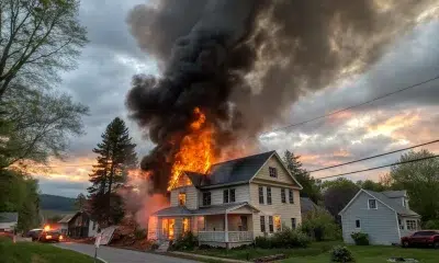 House engulfed in flames with thick black smoke