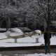 Snow-covered sculpture behind yellow caution tape
