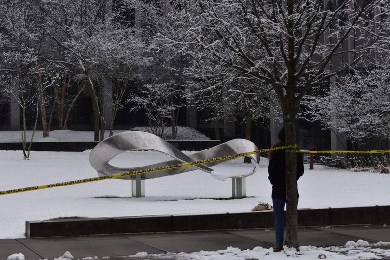 Snow-covered sculpture behind yellow caution tape