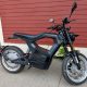Black SONDORS electric motorcycle parked by red wall