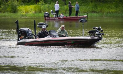 Two men fishing from bass boat on lake