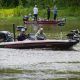 Two men fishing from bass boat on lake