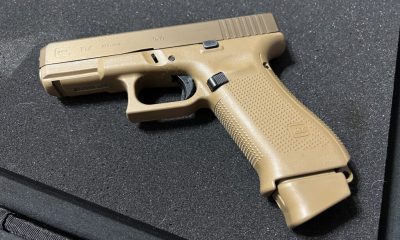 Tan Glock 19X handgun on black surface