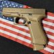 Tan Glock pistol on American flag