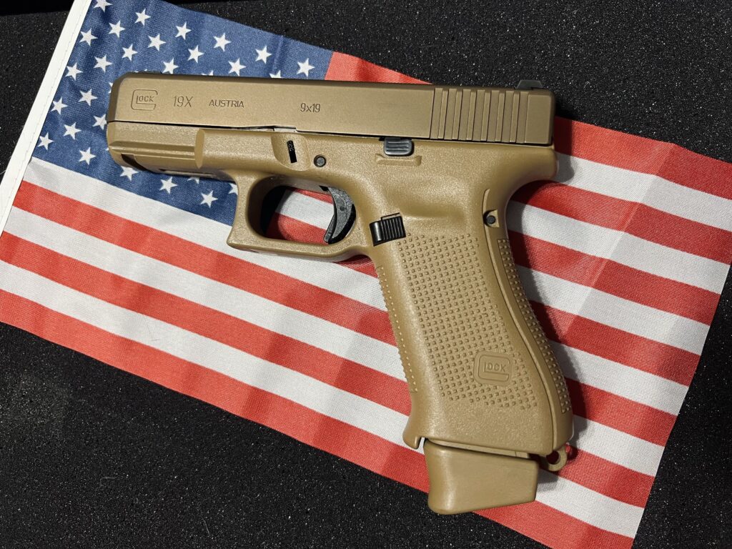 Tan Glock pistol on American flag