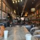 Industrial-style coffee shop interior with artwork and seating