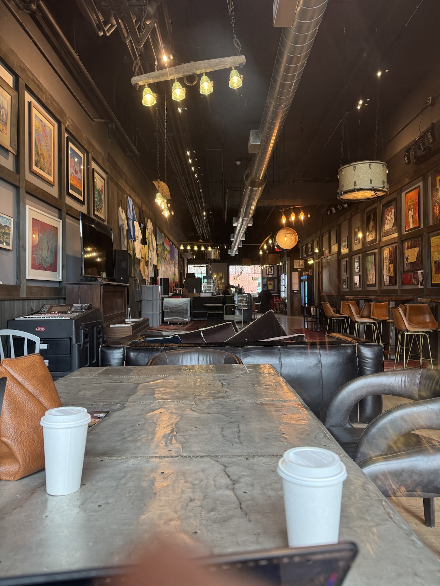 Industrial-style coffee shop interior with artwork and seating
