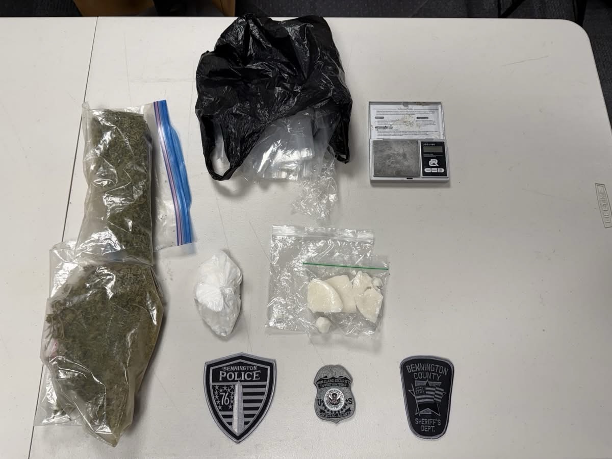 Seized drugs, scale, and police badges on table