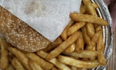 Burger and French fries in foil tray