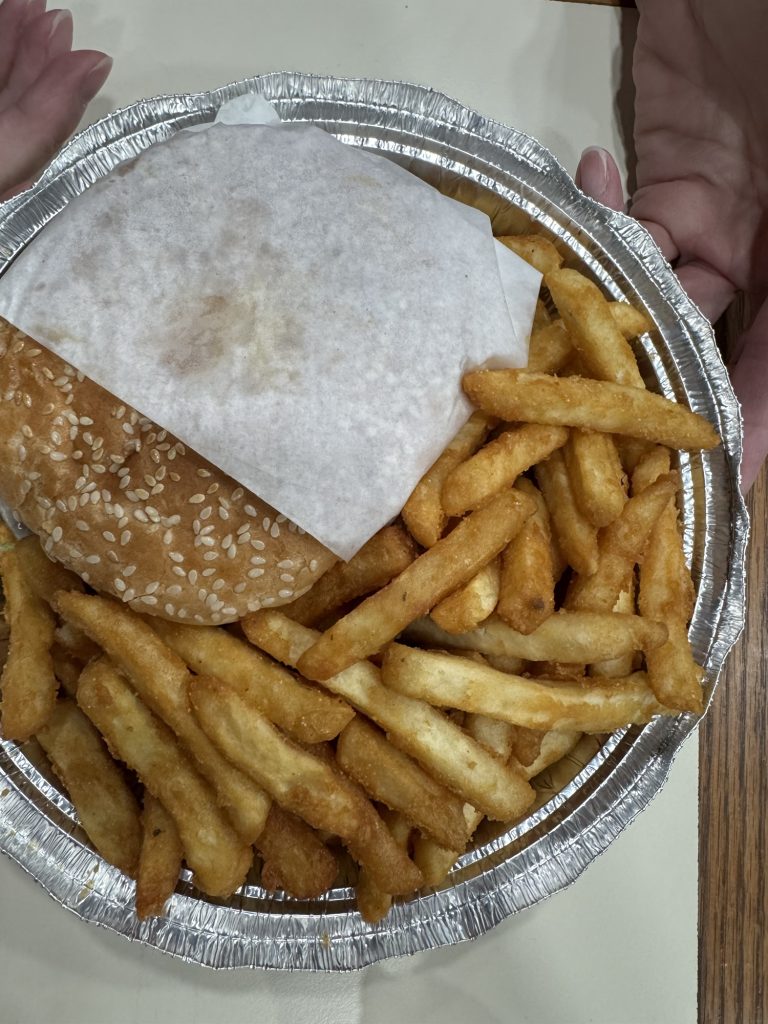 Burger and French fries in foil tray